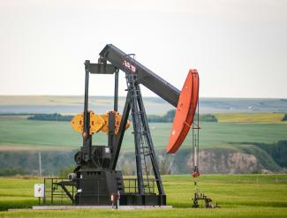 black and orange metal machine on green grass field during daytime by David Thielen courtesy of Unsplash.